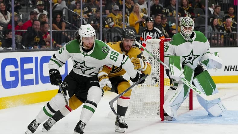 May 27, 2023; Las Vegas, Nevada, USA; Dallas Stars defenseman Thomas Harley (55) keeps the puck away from Vegas Golden Knights right wing Reilly Smith (19) during the second period in game five of the Western Conference Finals of the 2023 Stanley Cup Playoffs at T-Mobile Arena. Mandatory Credit: Stephen R. Sylvanie-USA TODAY Sports