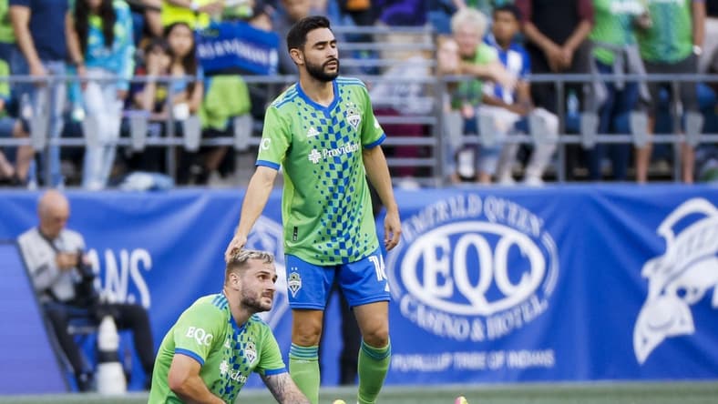 May 27, 2023; Seattle, Washington, USA; Seattle Sounders FC midfielder Alex Roldan (16) consoles forward Jordan Morris (13, bottom) following an injury to Morris during the first half against the New York Red Bulls at Lumen Field. Mandatory Credit: Joe Nicholson-USA TODAY Sports