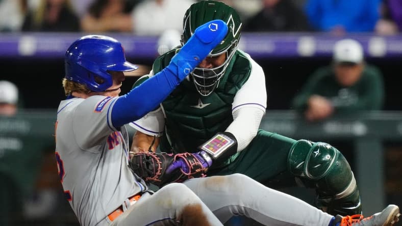 May 27, 2023; Denver, Colorado, USA; Colorado Rockies catcher Elias Diaz (35) tags out New York Mets third baseman Brett Baty (22) in the sixth inning at Coors Field. Mandatory Credit: Ron Chenoy-USA TODAY Sports