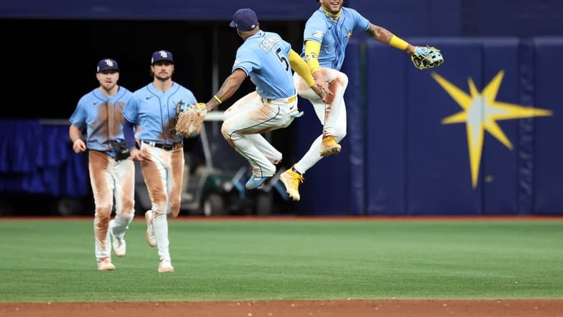 May 28, 2023; St. Petersburg, Florida, USA; Tampa Bay Rays center fielder Jose Siri (22), shortstop Wander Franco (5) and teammates celebrate as they beat the Los Angeles Dodgers at Tropicana Field. Mandatory Credit: Kim Klement-USA TODAY Sports