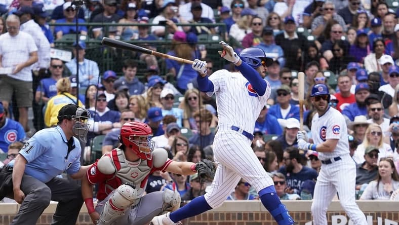 May 28, 2023; Chicago, Illinois, USA; Chicago Cubs center fielder Mike Tauchman (40) hits a single against the Cincinnati Reds during the fourth inning at Wrigley Field. Mandatory Credit: David Banks-USA TODAY Sports