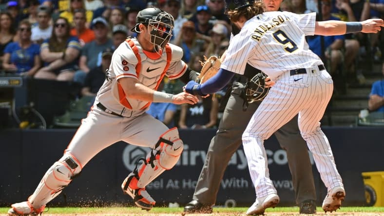 May 28, 2023; Milwaukee, Wisconsin, USA; San Francisco Giants catcher Blake Sabol (2) tags out Milwaukee Brewers third baseman Brian Anderson (9) in the first inning at American Family Field. Mandatory Credit: Benny Sieu-USA TODAY Sports
