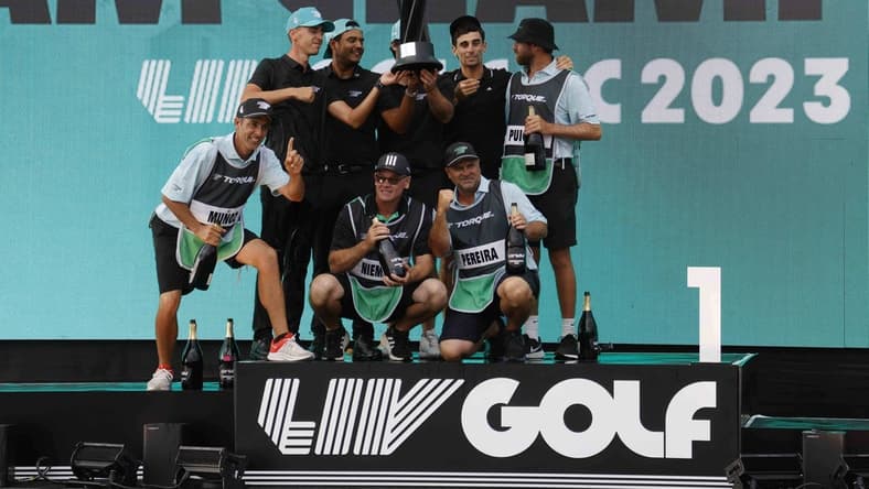 May 28, 2023; Potomac Falls, Virginia, USA; Members of Team Torque celebrate on the podium after winning the team championship of LIV Golf Washington, D.C. golf tournament at Trump National. Mandatory Credit: Geoff Burke-USA TODAY Sports