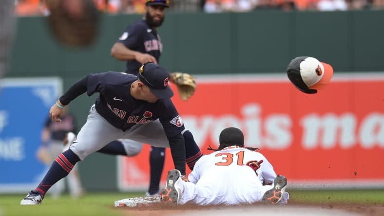 May 29, 2023; Baltimore, Maryland, USA;  Cleveland Guardians second baseman Andres Gimenez (0) tags Baltimore Orioles center fielder Cedric Mullins (31) out on a first inning steal attempts at Oriole Park at Camden Yards. Mandatory Credit: Tommy Gilligan-USA TODAY Sports