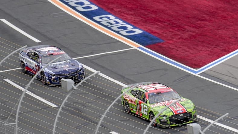 May 29, 2023; Concord, North Carolina, USA; NASCAR Cup Series driver Ryan Blaney (12) takes the lead from driver William Byron (24) during the Coca-Cola 600 at Charlotte Motor Speedway. Mandatory Credit: Jim Dedmon-USA TODAY Sports