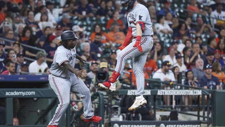 May 29, 2023; Houston, Texas, USA; Minnesota Twins catcher Ryan Jeffers (27) celebrates with third base coach/outfield coach Tommy Watkins (40) after hitting a home run during the tenth inning against the Houston Astros at Minute Maid Park. Mandatory Credit: Troy Taormina-USA TODAY Sports