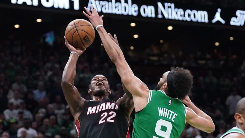 May 29, 2023; Boston, Massachusetts, USA; Miami Heat forward Jimmy Butler (22) shoots against Boston Celtics guard Derrick White (9) in the second quarter during game seven of the Eastern Conference Finals for the 2023 NBA playoffs at TD Garden. Mandatory Credit: David Butler II-USA TODAY Sports