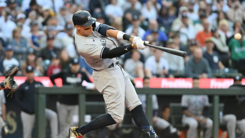 May 29, 2023; Seattle, Washington, USA; New York Yankees right fielder Aaron Judge (99) hits a two-run home run against the Seattle Mariners during the third inning at T-Mobile Park. Mandatory Credit: Steven Bisig-USA TODAY Sports