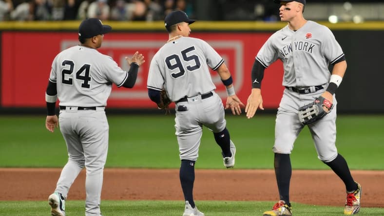 May 29, 2023; Seattle, Washington, USA; New York Yankees designated hitter Willie Calhoun (24) and third baseman Oswaldo Cabrera (95), and right fielder Aaron Judge (99) celebrate defeating the Seattle Mariners at T-Mobile Park. Mandatory Credit: Steven Bisig-USA TODAY Sports