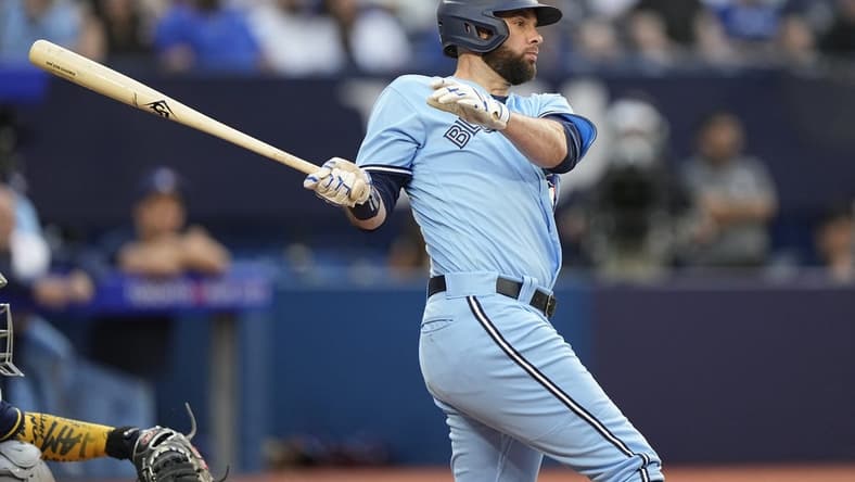 May 30, 2023; Toronto, Ontario, CAN; Toronto Blue Jays designated hitter Brandon Belt (13) hits an RBI single against the Milwaukee Brewers during the second inning at Rogers Centre. Mandatory Credit: John E. Sokolowski-USA TODAY Sports