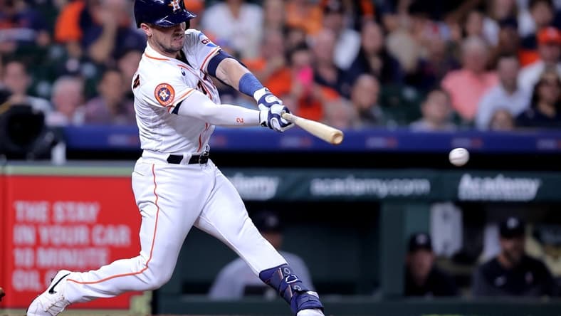 May 30, 2023; Houston, Texas, USA; Houston Astros third baseman Alex Bregman (2) hits a RBI single against the Minnesota Twins during the third inning at Minute Maid Park. Mandatory Credit: Erik Williams-USA TODAY Sports