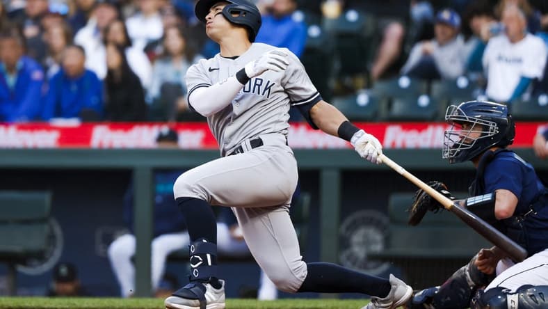 May 30, 2023; Seattle, Washington, USA; New York Yankees shortstop Anthony Volpe (11) hits a three-run home run against the Seattle Mariners during the third inning at T-Mobile Park. Mandatory Credit: Joe Nicholson-USA TODAY Sports