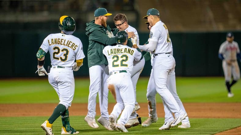 May 30, 2023; Oakland, California, USA; Oakland Athletics third baseman Jonah Bride (26) and designated hitter Ramon Laureano (22) and catcher Shea Langeliers (23) and teammates celebrate after the game against the Atlanta Braves[ at Oakland-Alameda County Coliseum. Mandatory Credit: Neville E. Guard-USA TODAY Sports