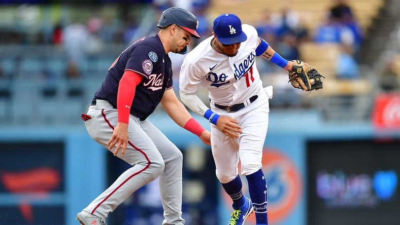 May 31, 2023; Los Angeles, California, USA; Washington Nationals designated hitter Joey Meneses (45) gets back to second against Los Angeles Dodgers shortstop Miguel Rojas (11) during the fifth inning at Dodger Stadium. Mandatory Credit: Gary A. Vasquez-USA TODAY Sports