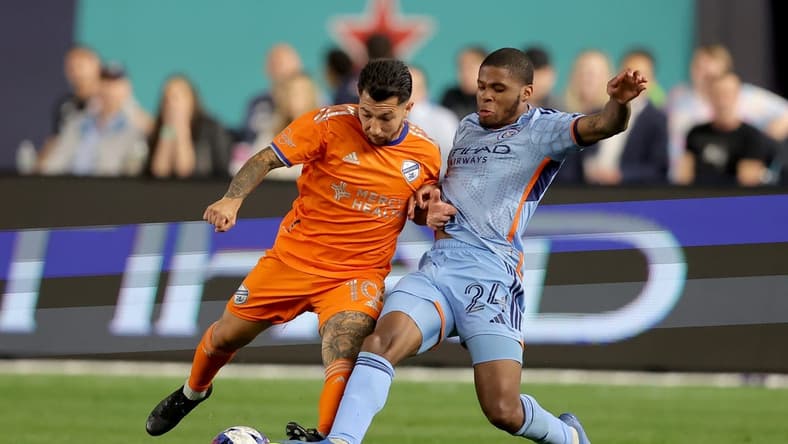 May 31, 2023; New York, New York, USA; FC Cincinnati midfielder Luciano Acosta (10) and New York City FC defender Tayvon Gray (24) fight for the ball during the second half at Yankee Stadium. Mandatory Credit: Brad Penner-USA TODAY Sports