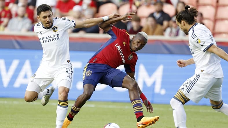 May 31, 2023; Sandy, Utah, USA; Los Angeles Galaxy midfielder Marco Delgado (8) and Real Salt Lake forward Carlos Andres Gomez (11) battle in the first half at America First Field. Mandatory Credit: Jeff Swinger-USA TODAY Sports