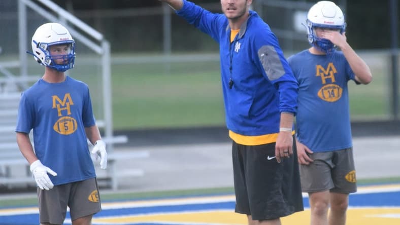 Mountain Home assistant coach Ryan Mallett gives instructions during a recent practice as Bombers Dillon Drewry (left) and Daxton Hickman (right) listen at Bomber Stadium. Fans must buy tickets in advance to attend the Bombers' scrimmage on Thursday against Highland. No tickets will be sold at the gate.

Dsc 6234