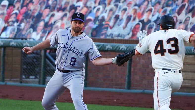 Sep 24, 2020; San Francisco, California, USA; Colorado Rockies first baseman Daniel Murphy (9) makes an out to retire San Francisco Giants catcher Tyler Heineman (43) during the eleventh inning at Oracle Park. Mandatory Credit: Kelley L Cox-USA TODAY Sports