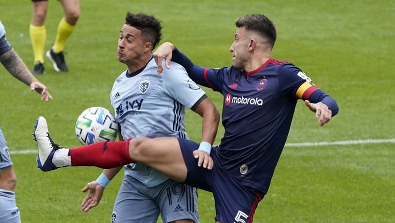 Oct 17, 2020; Chicago, Illinois, USA; Chicago Fire defender Francisco Calvo (5) kicks the ball away from Sporting Kansas City forward Erik Hurtado (19) during the second half at Soldier Field. Mandatory Credit: Mike Dinovo-USA TODAY Sports