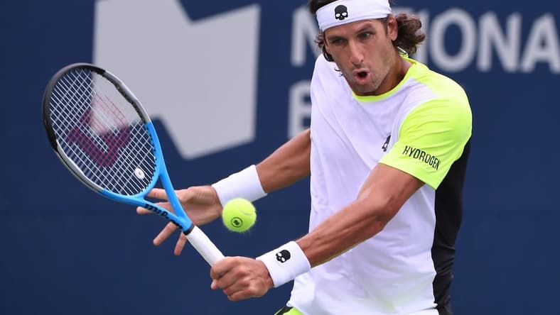 Aug 8, 2021; Toronto, Ontario, Canada; Feliciano Lopez of Spain plays a shot against Yoshihito Nishioka of Japan during second round qualifying for the National Bank Open. Mandatory Credit: Dan Hamilton-USA TODAY Sports