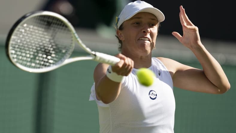 Jun 30, 2022; London, United Kingdom; Iga Swiatek (POL) returns a shot during her match against Lesley Pattinama Kerkhove (NED) on day four at All England Lawn Tennis and Croquet Club. Mandatory Credit: Susan Mullane-USA TODAY Sports