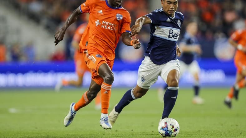 Jul 13, 2022; Cincinnati, Ohio, USA; FC Cincinnati midfielder Obinna Nwobodo (5) battles for the ball against Vancouver Whitecaps midfielder Michael Baldisimo (33) in the second half at TQL Stadium. Mandatory Credit: Katie Stratman-USA TODAY Sports