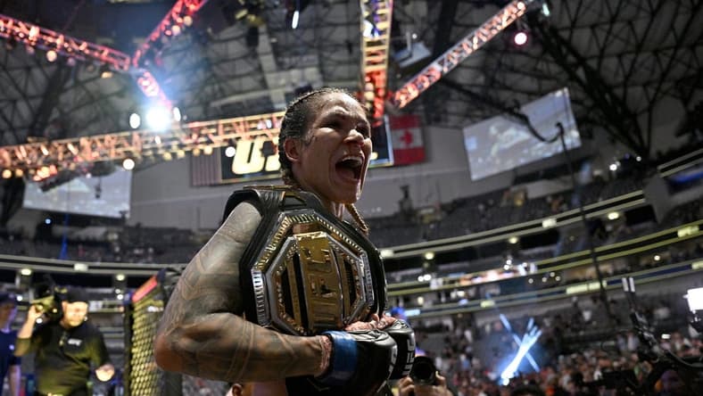 Jul 30, 2022; Dallas, TX, USA; Amanda Nunes (blue gloves) reacts after defeating Julianna Pena (not pictured) in a women   s bantamweight title bout during UFC 277 at the American Airlines Center. Mandatory Credit: Jerome Miron-USA TODAY Sports