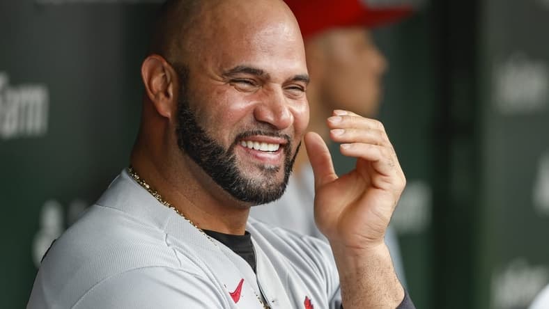 Aug 25, 2022; Chicago, Illinois, USA; St. Louis Cardinals designated hitter Albert Pujols (5) smiles in the dugout during the ninth inning against the Chicago Cubs at Wrigley Field. Mandatory Credit: Kamil Krzaczynski-USA TODAY Sports