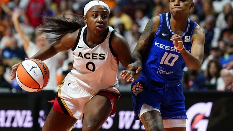 Sep 15, 2022; Uncasville, Connecticut, USA; Las Vegas Aces guard Jackie Young (0) drives the ball against Connecticut Sun guard Courtney Williams (10) in the second half during game three of the 2022 WNBA Finals at Mohegan Sun Arena. Mandatory Credit: David Butler II-USA TODAY Sports