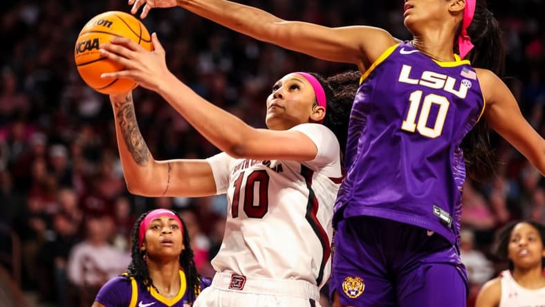 Feb 12, 2023; Columbia, South Carolina, USA; South Carolina Gamecocks center Kamilla Cardoso (10) drives past LSU Lady Tigers forward Angel Reese (10) in the first half at Colonial Life Arena. Mandatory Credit: Jeff Blake-USA TODAY Sports
