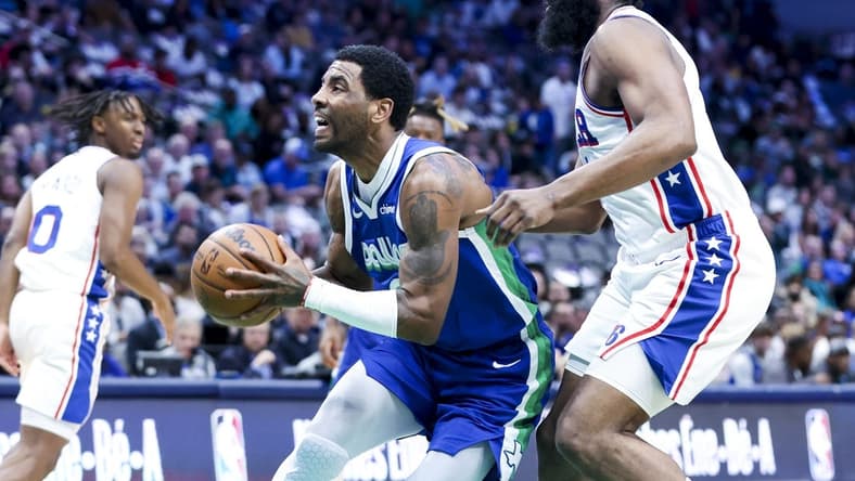 Mar 2, 2023; Dallas, Texas, USA;  Dallas Mavericks guard Kyrie Irving (2) drives to the basket past Philadelphia 76ers guard James Harden (1) during the first quarter at American Airlines Center. Mandatory Credit: Kevin Jairaj-USA TODAY Sports