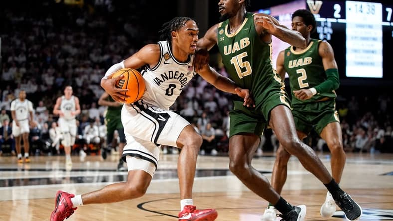 Vanderbilt guard Tyrin Lawrence (0) works the ball past UAB forward Ty Brewer (15) during the first half of an NIT quarterfinal game at Memorial Gym in Nashville, Tenn., Wednesday, March 22, 2023.

Vandynit 032223 An 005