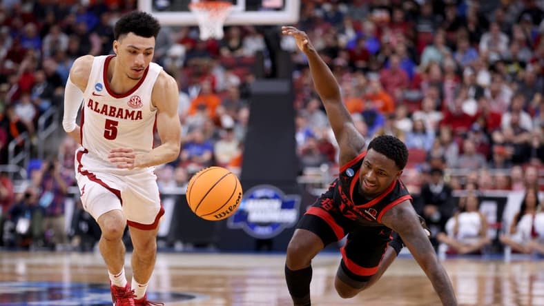 Mar 24, 2023; Louisville, KY, USA; San Diego State Aztecs guard Darrion Trammell (12) and Alabama Crimson Tide guard Jahvon Quinerly (5) chase a loose ball during the second half of the NCAA tournament round of sixteen at KFC YUM! Center. Mandatory Credit: Jordan Prather-USA TODAY Sports