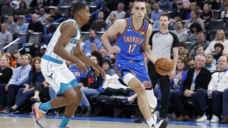 Mar 28, 2023; Oklahoma City, Oklahoma, USA; Oklahoma City Thunder forward Aleksej Pokusevski (17) dribbles the ball against Charlotte Hornets guard Theo Maledon (9) during the second half at Paycom Center. Charlotte defeated Oklahoma City 137-134. Mandatory Credit: Alonzo Adams-USA TODAY Sports