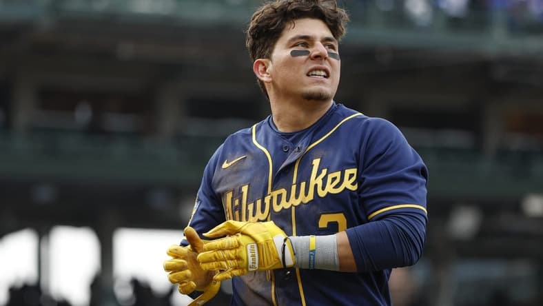 Mar 30, 2023; Chicago, Illinois, USA; Milwaukee Brewers third baseman Luis Urias (2) reacts after being tagged out at first base during the ninth inning at Wrigley Field. Mandatory Credit: Kamil Krzaczynski-USA TODAY Sports