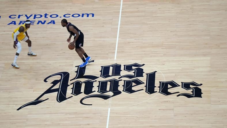 Apr 5, 2023; Los Angeles, California, USA; A general overall view as LA Clippers forward Kawhi Leonard (2) dribbles the ball against Los Angeles Lakers forward Jarred Vanderbilt (2) at midcourt on the Clippers Los Angeles logo in the first half at Crypto.com Arena. Mandatory Credit: Kirby Lee-USA TODAY Sports