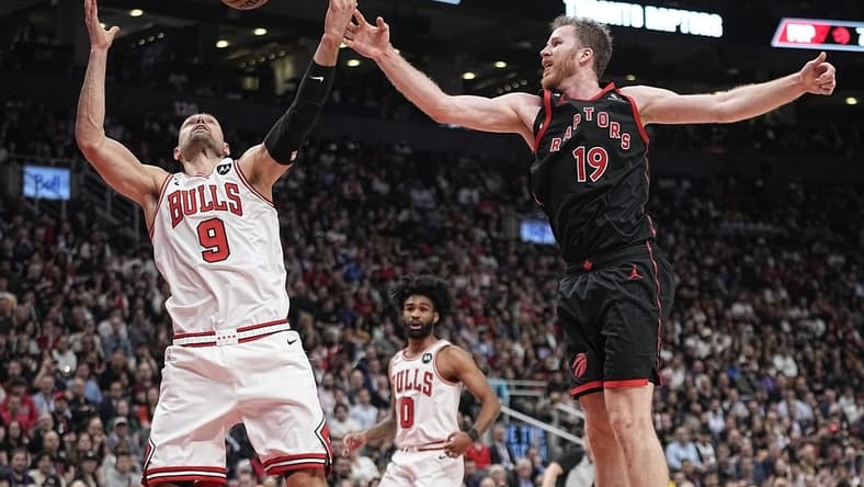 Apr 12, 2023; Toronto, Ontario, CAN; Chicago Bulls center Nikola Vucevic (9) and Toronto Raptors center Jakob Poeltl (19) battle for a rebound during the second half of a NBA Play-In game at Scotiabank Arena. Mandatory Credit: John E. Sokolowski-USA TODAY Sports