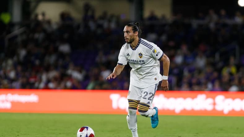 Apr 29, 2023; Orlando, Florida, USA; Los Angeles Galaxy defender Martin Caceres (22) dribbles the ball into Orlando City SC   s half in the second half at Exploria Stadium. Mandatory Credit: Morgan Tencza-USA TODAY Sports
