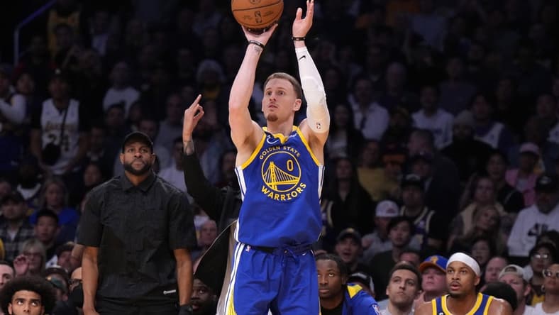May 8, 2023; Los Angeles, California, USA; Golden State Warriors guard Donte DiVincenzo (0) shoots the ball against the Los Angeles Lakers in the second half of game four of the 2023 NBA playoffs at Crypto.com Arena. Mandatory Credit: Kirby Lee-USA TODAY Sports