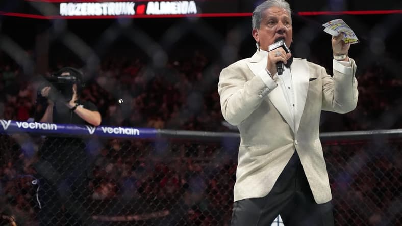 May 13, 2023; Charlotte, North Carolina, USA; Ring announcer Bruce Buffer introduces the fighters before a a heavyweight bout between Jairzinho Rozenstruik (red gloves) and Jailton Almeida  (blue gloves) during UFC Fight Night at Spectrum Center. Mandatory Credit: Jim Dedmon-USA TODAY Sports