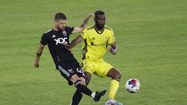 May 13, 2023; Washington, District of Columbia, USA; D.C. United midfielder Mateusz Klich (43) clears the ball from Nashville SC defender Shaq Moore (18) in the first half at Audi Field. Mandatory Credit: Geoff Burke-USA TODAY Sports
