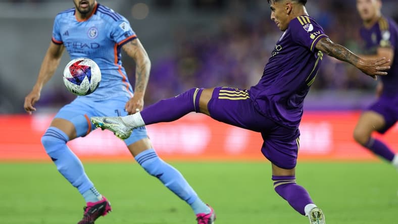 May 17, 2023; Orlando, Florida, USA; Orlando City SC forward Facundo Torres (17) clears at the ball from New York City FC defender Thiago Martins (13) in the first half at Exploria Stadium. Mandatory Credit: Nathan Ray Seebeck-USA TODAY Sports