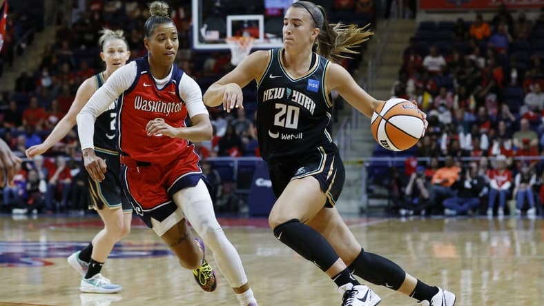 May 19, 2023; Washington, District of Columbia, USA; New York Liberty guard Sabrina Ionescu (20) drives to the basket as Washington Mystics guard Natasha Cloud (9) defends at Entertainment & Sports Arena. Mandatory Credit: Geoff Burke-USA TODAY Sports