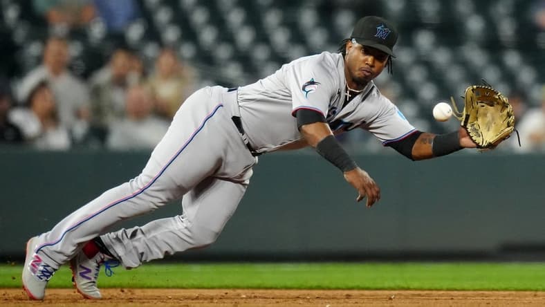 May 23, 2023; Denver, Colorado, USA; Miami Marlins third baseman Jean Segura (9) fields the ball in the sixth inning against the Colorado Rockies at Coors Field. Mandatory Credit: Ron Chenoy-USA TODAY Sports