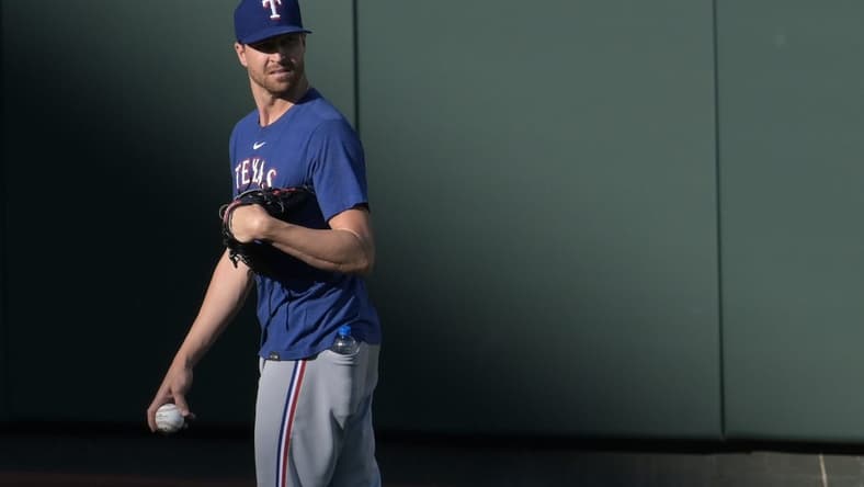 May 26, 2023; Baltimore, Maryland, USA;  Texas Rangers starting pitch Jacob deGrom stands in the outfield before the game against the Baltimore Orioles at Oriole Park at Camden Yards. Mandatory Credit: Tommy Gilligan-USA TODAY Sports