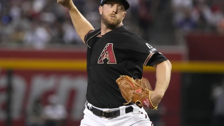 May 28, 2023; Phoenix, Arizona, USA; Arizona Diamondbacks starting pitcher Merrill Kelly (29) throws against the Boston Red Sox in the first inning at Chase Field. Mandatory Credit: Rick Scuteri-USA TODAY Sports