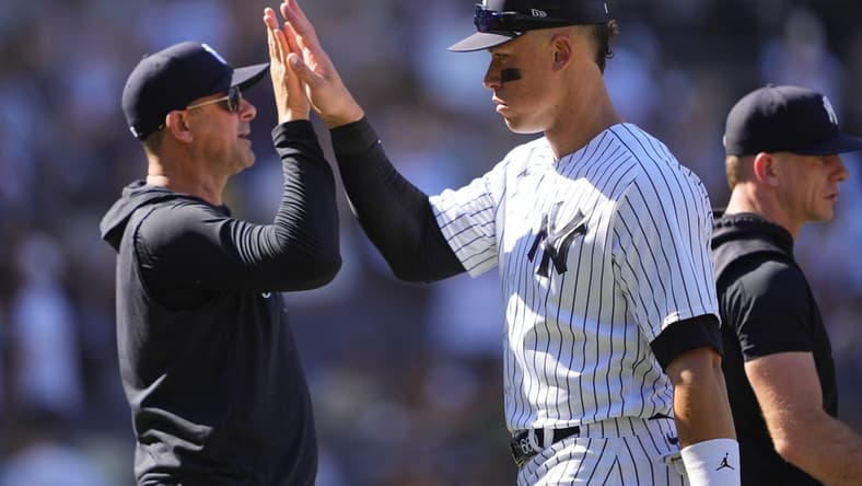May 28, 2023; Bronx, New York, USA; New York Yankees manager Aaron Boone (17) and right fielder Aaron Judge (99) celebrate the victory against the San Diego Padres after the game at Yankee Stadium. Mandatory Credit: Gregory Fisher-USA TODAY Sports