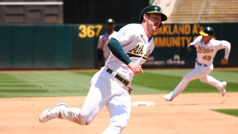 May 31, 2023; Oakland, California, USA; Oakland Athletics left fielder Brett Rooker (25) rounds third base ahead of first baseman Ryan Noda (49) to score a run against the Atlanta Braves during the sixth inning at Oakland-Alameda County Coliseum. Mandatory Credit: Kelley L Cox-USA TODAY Sports
