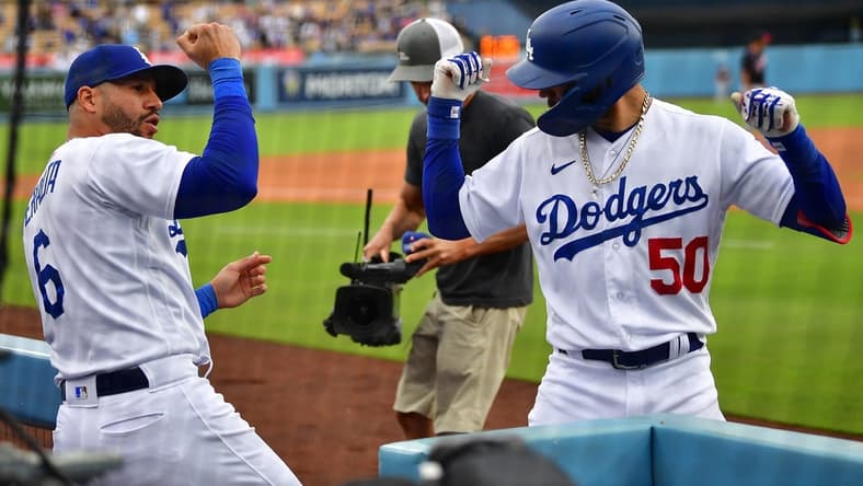 May 31, 2023; Los Angeles, California, USA; Los Angeles Dodgers right fielder Mookie Betts (50) celebrates his solo home run against the Washington Nationals with left fielder David Peralta (6) during the eighth inning at Dodger Stadium. Mandatory Credit: Gary A. Vasquez-USA TODAY Sports