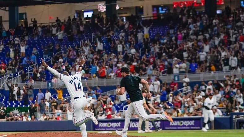 May 31, 2023; Miami, Florida, USA; Miami Marlins left fielder Bryan De La Cruz (14) runs onto the field after defeating the San Diego Padres at loanDepot Park. Mandatory Credit: Rich Storry-USA TODAY Sports